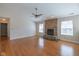 Bright living room features a brick fireplace, hardwood floors, and a ceiling fan at 4655 Welton St, Greenwood, IN 46143