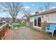 Wooden back deck featuring a patio table with chairs and sliding glass doors at 4911 Carry Back Ln, Indianapolis, IN 46237