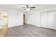 Bedroom with gray vinyl floors, ceiling fan, and convenient closet space at 4911 Carry Back Ln, Indianapolis, IN 46237