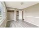 Bright bedroom features neutral walls, two closets, gray floors, and a large window at 4911 Carry Back Ln, Indianapolis, IN 46237