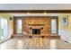 A stunning floor-to-ceiling brick fireplace is flanked by windows in this living area at 4911 Carry Back Ln, Indianapolis, IN 46237