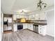 Bright kitchen with stainless steel appliances, gray backsplash, and white cabinetry at 4911 Carry Back Ln, Indianapolis, IN 46237