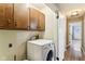 Laundry room featuring upper cabinets, washer, and doorway to another room at 4911 Carry Back Ln, Indianapolis, IN 46237