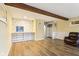 Open living space features wood floors, a built-in display case, and comfortable seating at 4911 Carry Back Ln, Indianapolis, IN 46237