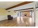Cozy living room with wood floors, a brick fireplace, and ample natural light at 4911 Carry Back Ln, Indianapolis, IN 46237