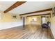 Spacious living room with wood floors, exposed beams, and natural light at 4911 Carry Back Ln, Indianapolis, IN 46237