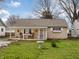 Charming single-story home with a covered front porch, flower boxes, and mature trees at 509 W Pierson St, Greenfield, IN 46140