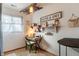 Well-lit home office space with a desk, chair, and decorative shelving for organization at 509 W Pierson St, Greenfield, IN 46140