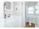 Bright bathroom featuring white wainscoting, modern vanity, and a shower at 6045 N 300 W, Greenfield, IN 46140