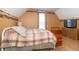 Well-lit bedroom showcasing a charming plaid bedspread and coordinating wood furnishings at 6045 N 300 W, Greenfield, IN 46140