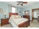 Charming bedroom with a wood-trimmed bed, matching dresser, and a ceiling fan for added comfort at 6045 N 300 W, Greenfield, IN 46140