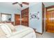 Cozy bedroom featuring a wooden dresser and wardrobe, paired with calm blue walls and a ceiling fan at 6045 N 300 W, Greenfield, IN 46140