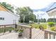 Inviting wooden deck with lush greenery and potted plants, offering serene outdoor space with scenic neighborhood views at 6045 N 300 W, Greenfield, IN 46140