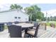 Enjoy outdoor dining on this wooden deck featuring a dining table set and beautiful landscaping, perfect for relaxation at 6045 N 300 W, Greenfield, IN 46140