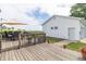 Enjoy outdoor dining on this wooden deck featuring a dining table with an umbrella, providing a perfect spot for relaxation at 6045 N 300 W, Greenfield, IN 46140