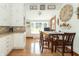 Cozy dining area adjacent to the kitchen with a view of the backyard through large windows at 6045 N 300 W, Greenfield, IN 46140
