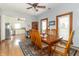 Open dining area with a wood table, view to kitchen, and a large window with natural light at 6045 N 300 W, Greenfield, IN 46140