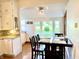 Bright dining room area with a large window overlooking the backyard and updated lighting at 6045 N 300 W, Greenfield, IN 46140
