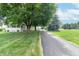 Paved driveway leading to a charming home with a well-maintained yard at 6045 N 300 W, Greenfield, IN 46140