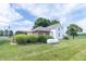 Exterior view of a farmhouse featuring white siding and a manicured lawn at 6045 N 300 W, Greenfield, IN 46140