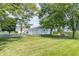Well-maintained property with three-car garage, mature trees, and expansive lawn at 6045 N 300 W, Greenfield, IN 46140