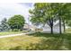 Landscaped property with circular driveway, three-car garage, and lush greenery at 6045 N 300 W, Greenfield, IN 46140