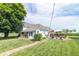 Charming two-story home with landscaped yard, deck, and beautiful curb appeal at 6045 N 300 W, Greenfield, IN 46140