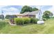 Farmhouse with a patio umbrella, mature foliage, and a manicured lawn at 6045 N 300 W, Greenfield, IN 46140