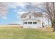 Attractive two-story white home with a screened-in porch and a big lawn in the front at 6045 N 300 W, Greenfield, IN 46140