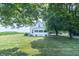 Two-story farmhouse with a screened-in porch and a view of a cornfield at 6045 N 300 W, Greenfield, IN 46140