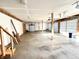 Spacious two-car garage with overhead doors, ample lighting, and unfinished walls at 6045 N 300 W, Greenfield, IN 46140