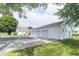 Detached three-car garage with gravel siding and a blacktop drive at 6045 N 300 W, Greenfield, IN 46140