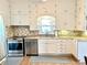 Well-lit kitchen featuring white cabinets, granite countertops, and stainless steel appliances at 6045 N 300 W, Greenfield, IN 46140