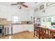 Modern kitchen leading to a dining area, with white cabinets and stainless steel appliances at 6045 N 300 W, Greenfield, IN 46140