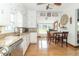 Well-lit kitchen with white cabinetry, granite countertops, and an adjoining dining area at 6045 N 300 W, Greenfield, IN 46140