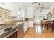 Bright and airy kitchen with updated appliances, granite counters, and view of the dining area at 6045 N 300 W, Greenfield, IN 46140