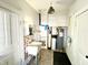 Functional laundry room with sink, storage cabinets, water heater, and white painted doors at 6045 N 300 W, Greenfield, IN 46140
