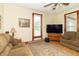 Comfortable living room with a cozy sofa, large TV, and an area rug adding warmth to the space at 6045 N 300 W, Greenfield, IN 46140