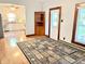Bright living room features hardwood floors, a decorative rug, and a view into the kitchen at 6045 N 300 W, Greenfield, IN 46140