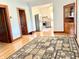 Bright living room features hardwood floors, a decorative rug, and a view into the kitchen at 6045 N 300 W, Greenfield, IN 46140