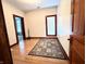 Inviting living room featuring wood floors, a decorative rug, and natural light from a window at 6045 N 300 W, Greenfield, IN 46140