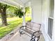 Inviting front porch with a bench, hanging fern, and a view of the landscaped yard at 6045 N 300 W, Greenfield, IN 46140