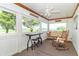 Relaxing screened porch with bistro table, chairs, a swing, and views of the surrounding landscape at 6045 N 300 W, Greenfield, IN 46140