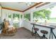 Relaxing screened porch with bistro table, chairs, and scenic views of the surrounding landscape at 6045 N 300 W, Greenfield, IN 46140