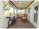 Relaxing screened porch with bistro table, chairs, a swing, and views of the surrounding landscape at 6045 N 300 W, Greenfield, IN 46140