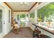 Relaxing screened porch with rocking chair, bistro table, and scenic views of the surrounding landscape at 6045 N 300 W, Greenfield, IN 46140