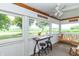 Relaxing screened porch with bistro table, chairs, a swing, and views of the surrounding landscape at 6045 N 300 W, Greenfield, IN 46140