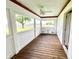 Relaxing sunroom with wood flooring, a ceiling fan, and scenic outdoor views at 6045 N 300 W, Greenfield, IN 46140