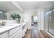 A stylish bathroom with a double vanity, quartz countertop, white cabinetry, and a glass-enclosed shower at 620 Corbin Way, Avon, IN 46123