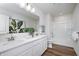 Well-lit bathroom featuring dual sinks, white cabinets, a large mirror, quartz countertops, and a tub-shower combo at 620 Corbin Way, Avon, IN 46123